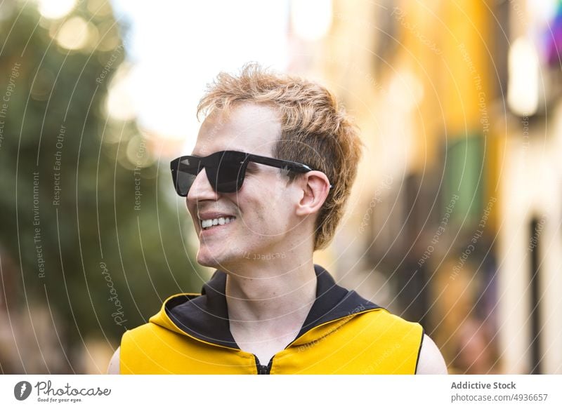 Smiling stylish non binary male on street man style urban cheerful delight transgender confident modern lgbt walk glad young happy smile lgbtq sunglasses