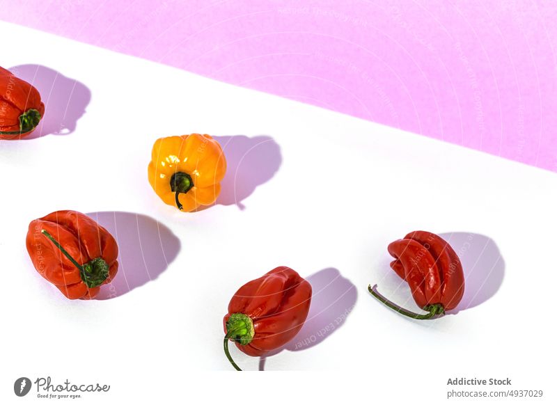 Red and yellow fresh peppers on table unique concept red single unusual ripe vegetable healthy food paprika ingredient natural vitamin raw vegetarian nutrition