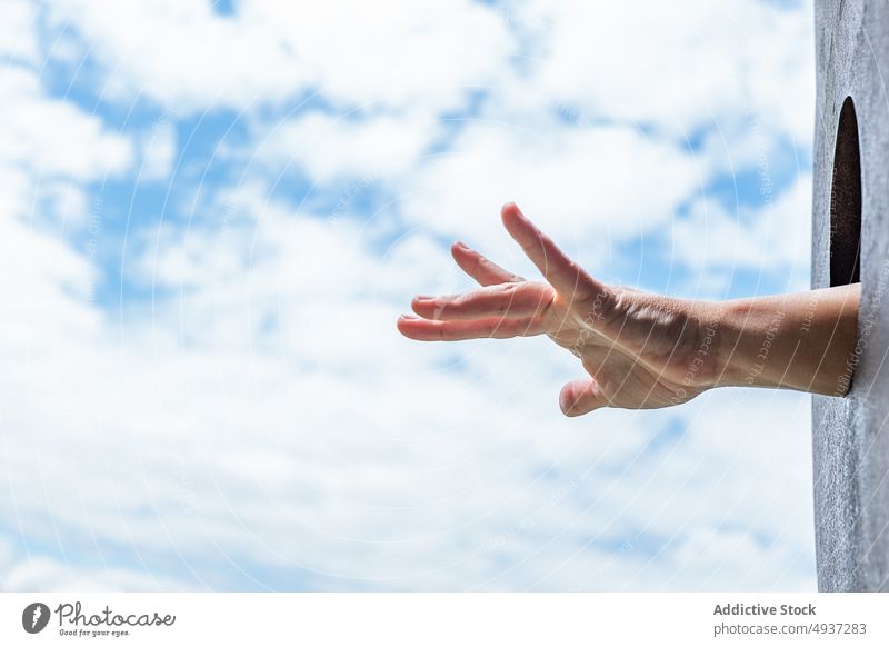 Crop person sticking out hand from hole stick out playground blue sky cloudy weekend summer park daytime show outstretch weather circle construction recreation