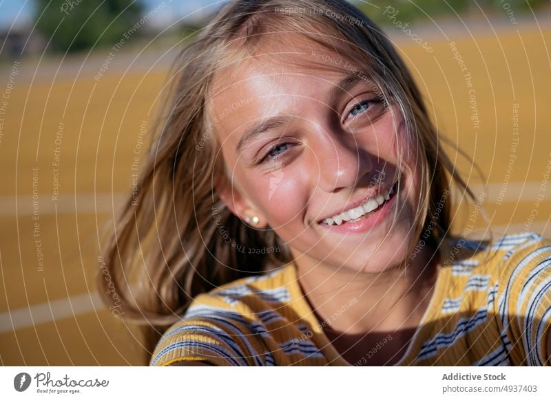 Smiling girl taking selfie on street teenage self portrait photography city social media happy kid cheerful positive playground optimist glad smile charming