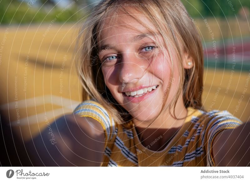 Smiling girl taking selfie on street teenage self portrait photography city social media happy kid cheerful positive playground optimist glad smile charming