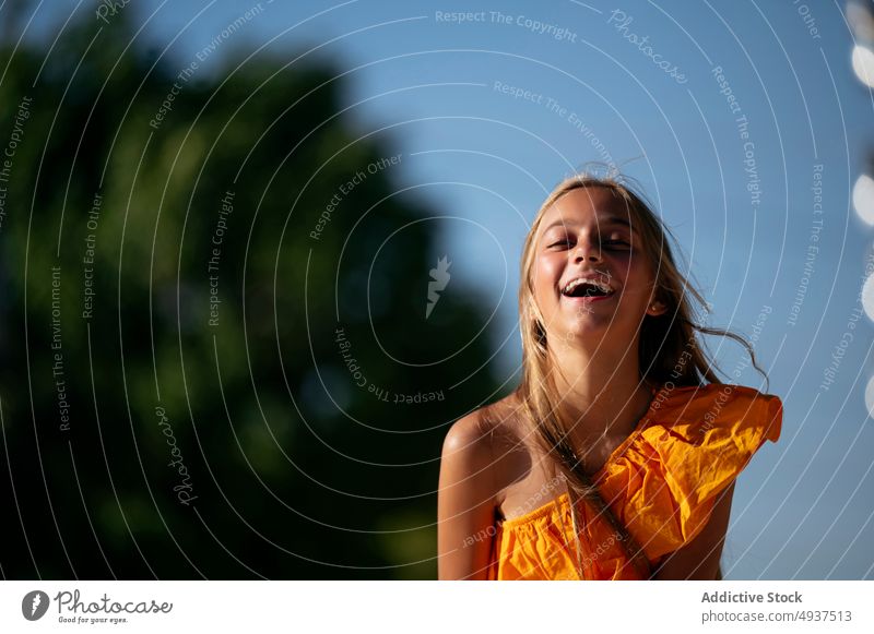 Joyful girl standing on street teenage having fun city carefree pastime leisure style active funny summer cheerful cute kid adorable motion long hair appearance