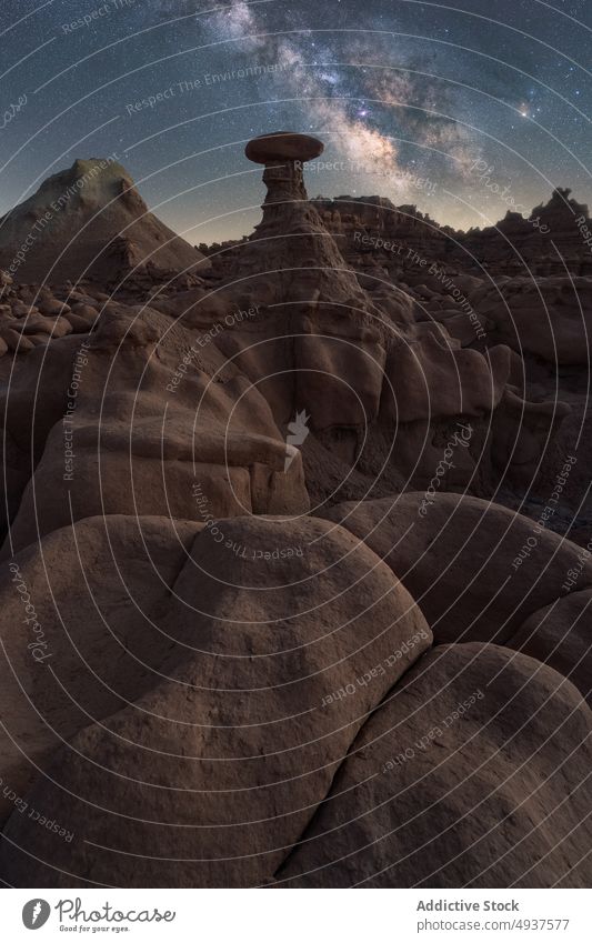 Stone formation against starry sky stone desert hole sand dry ground landscape rock arid geology terrain night dark boulder rough drought picturesque unusual