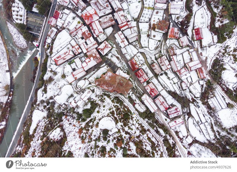 Snowy town in mountains on gloomy day in Spain scenic untouched fanlo village season coniferous wild from above valley scenery remote neighborhood terrain