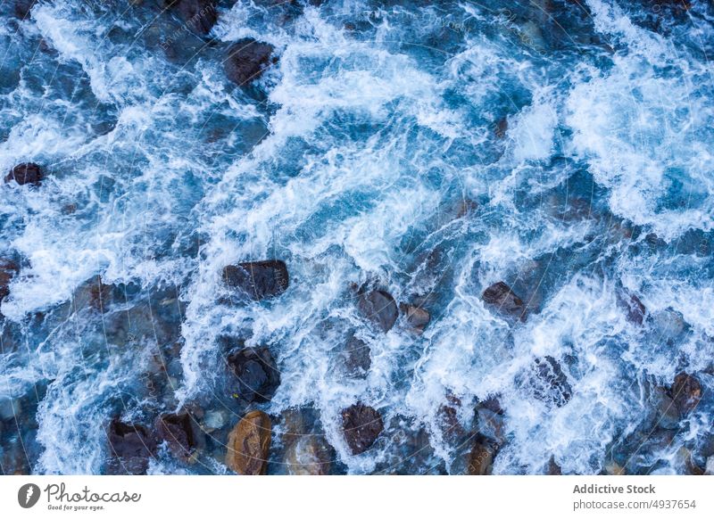 Cliff with fast river in nature water cliff rock stream clean power rough daytime flow countryside splash rapid creek formation brook energy geology clear