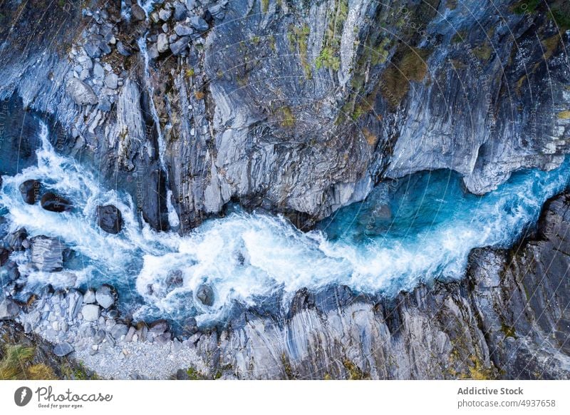 Cliff with fast waterfall in nature cliff rock stream clean power rough river daytime flow countryside cascade splash rapid creek formation brook energy geology