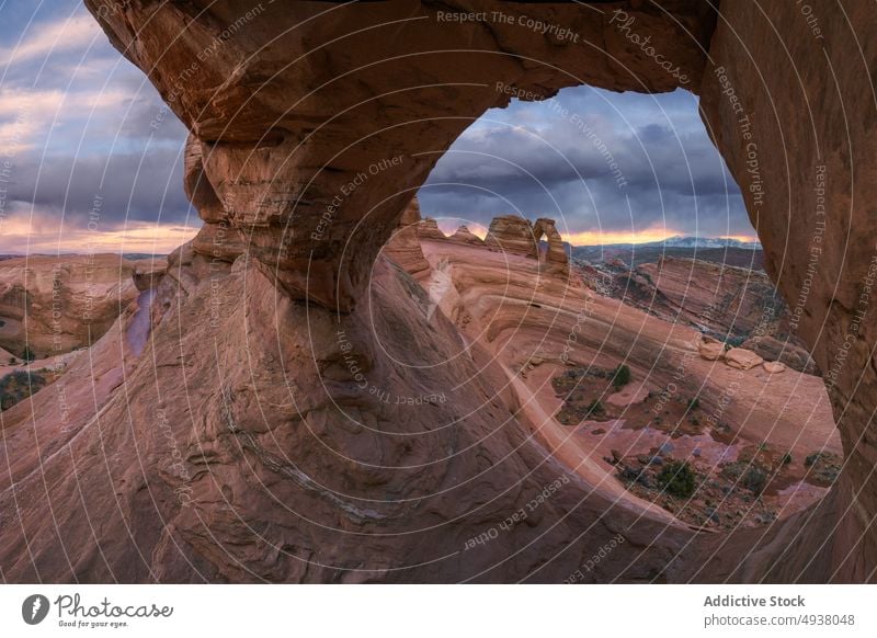 Natural stone arch against cloudy sky formation natural sunset storm desert arid delicate arch arches national park moab utah usa united states america