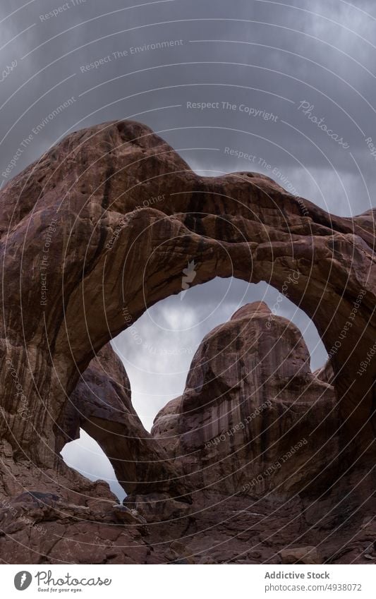 Stone arches on cloudy day in desert stone formation sky weather rough arid nature double arch arches national park moab utah usa united states america rock