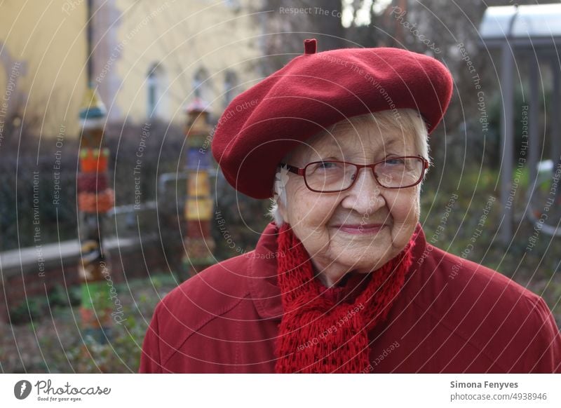 The woman with red beret old lady grandma Grandmother Red Red clothes pensive Smiling wrinkled face portrait red scarf short gray hair Old Mature woman