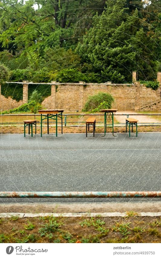 Empty beer garden Table Folding table Bench folding bench Beer garden Snack bar Gastronomy Street off Deserted Gloomy melancholy Street party inanimate Wait