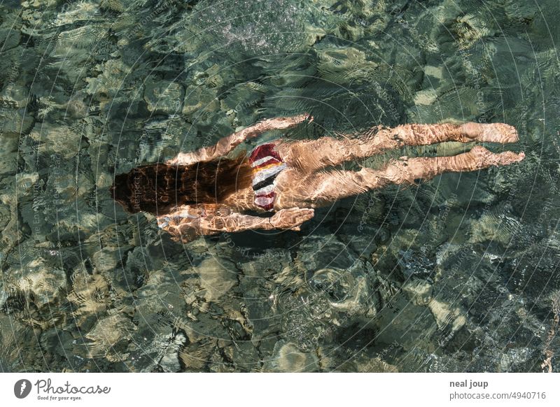 Young woman in bikini swims and dives through crystal clear sea water Ocean Water be afloat Dive Woman Elegant Bikini Youth (Young adults) Swimming & Bathing