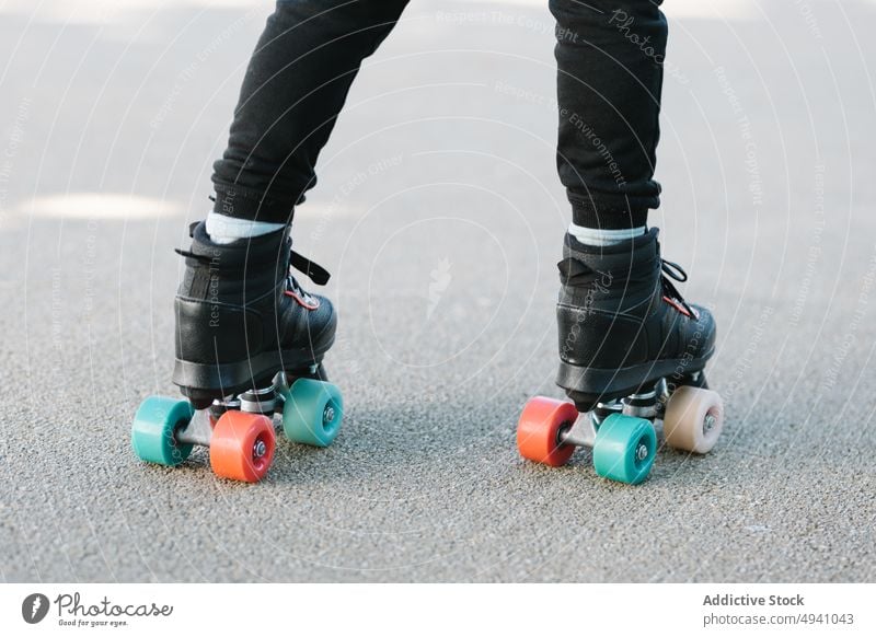 Crop child walking in roller skates park path summer asphalt weekend activity hobby childhood ride daytime way street kid season alley recreation free time