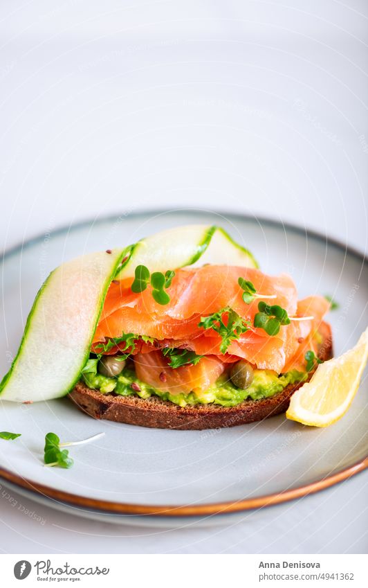 Toast with avocado and salmon toast smoked salmon mashed bread lunch breakfast fresh food fish healthy delicious snack gourmet meal slice sandwich cheese