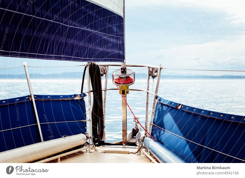 Foresail and tip of a sailbaot on a tranquil day on the water foresail front sailboat travel nature vacation summer tourism ocean blue nautical landscape sport