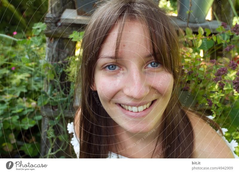 Young woman in the garden smiling summery into the camera. youthful teenager Youth (Young adults) Garden Summer Green Girl Human being Nature Smiling Happy Joy