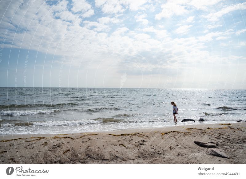 Child devotional on Baltic Sea beach Beach Sandy beach Ocean Water Barefoot Summer sunny cloud play Northern Germany Schleswig-Holstein North Sea attentiveness