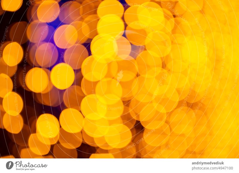 Abstract circular bokeh background of Christmaslight. bokeh from garlands. background for screensaver. Defocused lights. Blurred bokeh with yellow color lights.