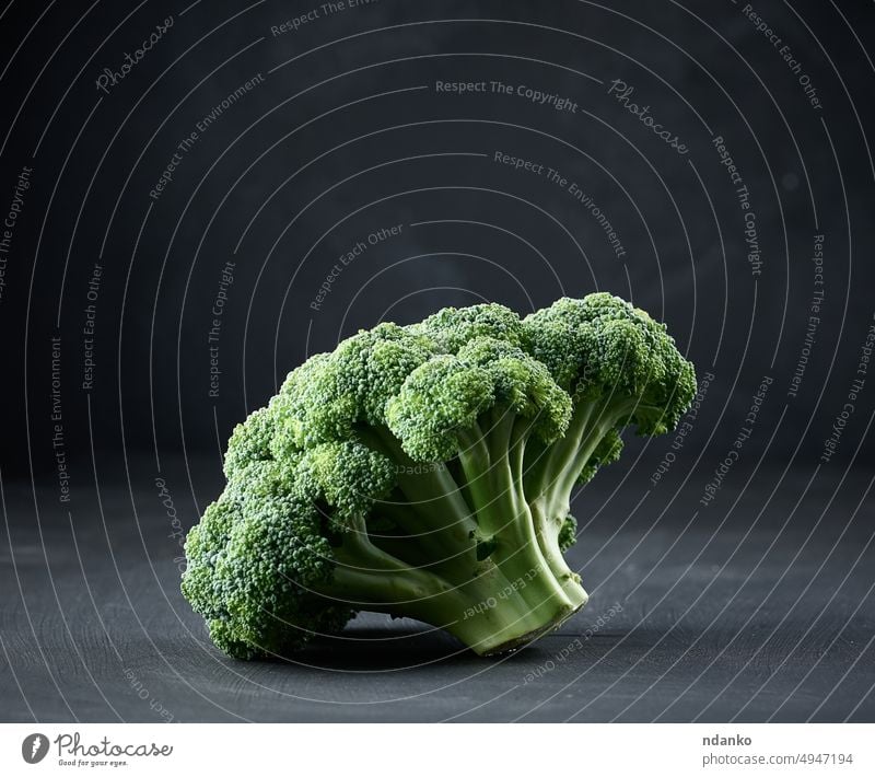 Fresh green head of broccoli on black background vegetable food healthy raw organic fresh diet vegetarian ingredient nourishment ripe vitamin salad cabbage