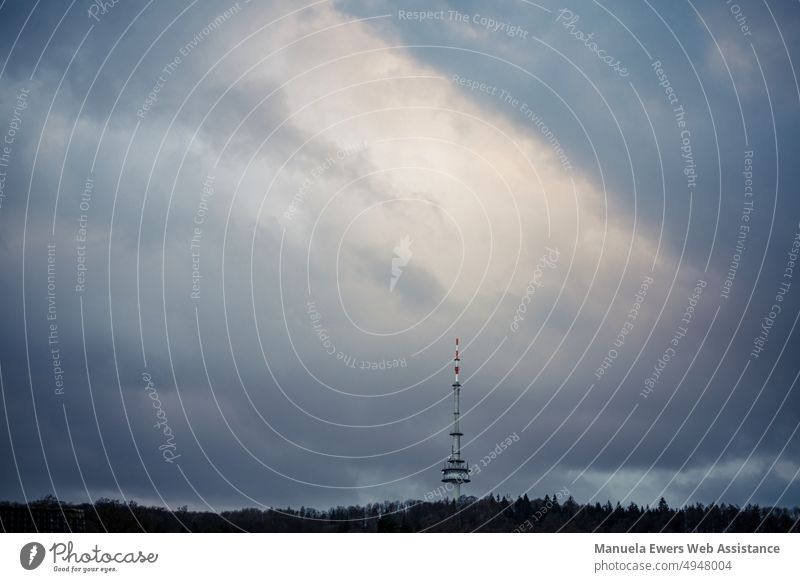 The cloud cover over the Bielefeld TV tower seems to break up a bit Television tower hünenburg Teutoburg Forest stormy sky Dark clouds somber Highlights