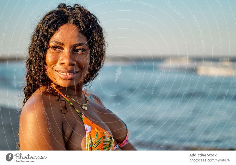 Happy black woman near sea beach smile tourist weekend happy bikini summer vacation female wave resort african american ethnic holiday optimist glad tourism