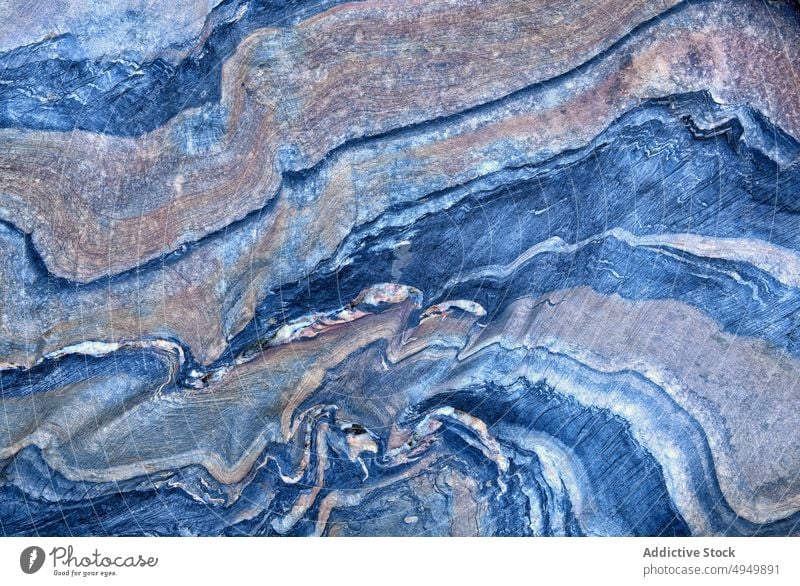 Surface of blue metamorphic rock abstract ornament smooth wavy background texture natural surface material mineral fragment uneven effect curve detail part