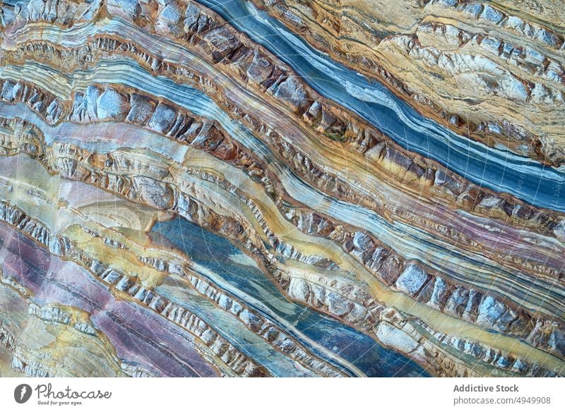 Surface of blue metamorphic rock abstract ornament smooth wavy background texture natural surface material mineral fragment uneven effect curve detail part