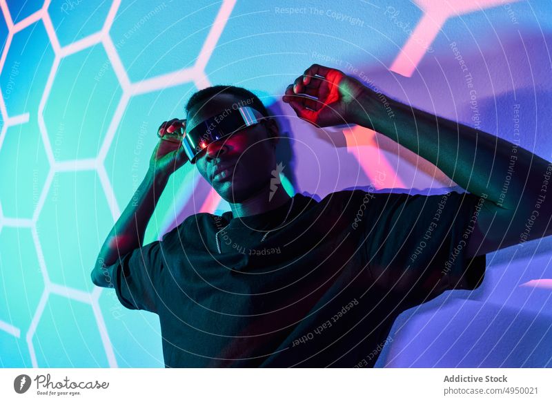 Confident black man in futuristic headset reaching out hand to camera reach out virtual reality digital serious vr cyberspace portrait innovation experience