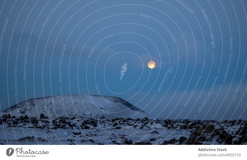 Moon over mountain in winter moon night cloudless sky snow nature shine cold dark iceland spectacular breathtaking evening picturesque scenic terrain frozen