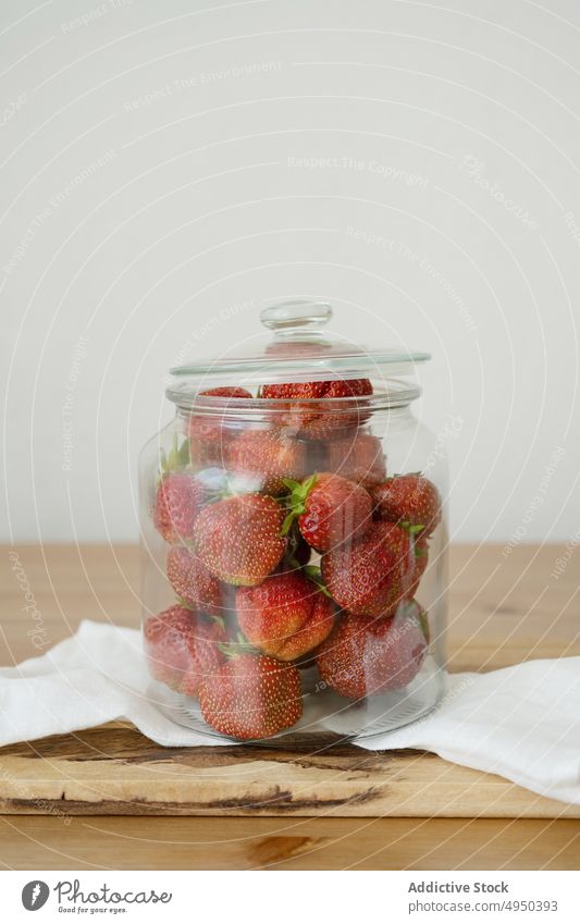 Glass jar with fresh strawberries on wooden table strawberry kitchen food healthy food vitamin cutting board whole ripe delicious ingredient fruit yummy tasty