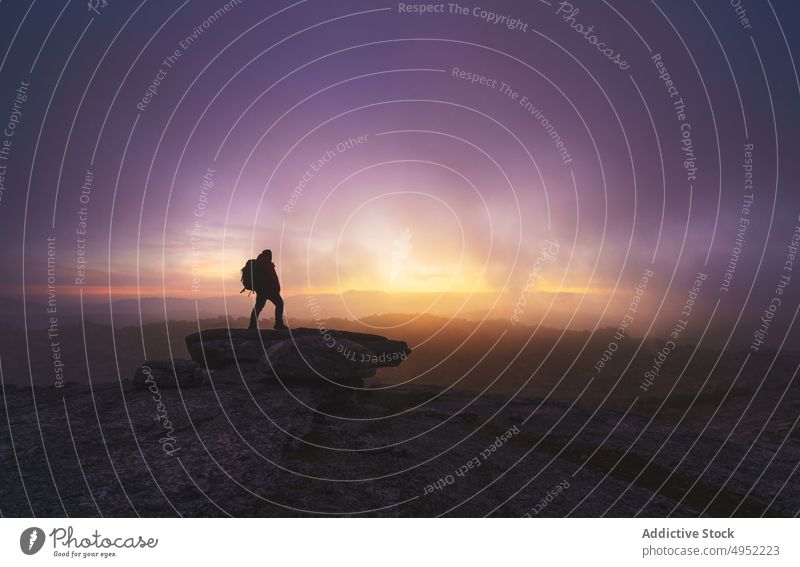 Silhouette of a man explorer on some mountain rocks at sunrise silhouette nature sunset outdoor travel sky valley horizon landscape no people scenery clouds