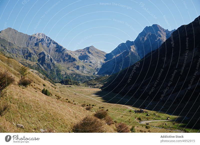 Valley with rough rocky mountains nature pyrenees ridge stone valley field range scenic landscape environment destination high blue sky slope sunlight scenery