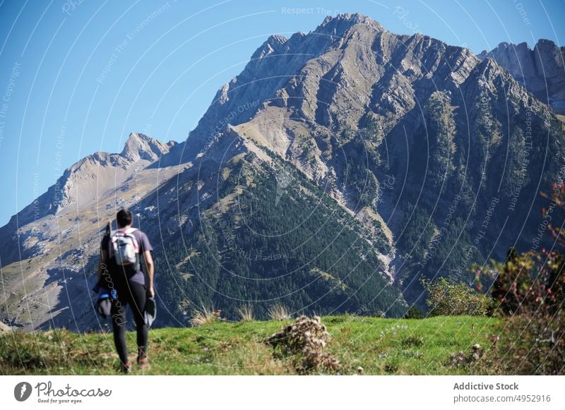 Unrecognizable traveler admiring rocky mountains tourist tourism hike nature pyrenees ridge journey stone slope range rough landscape environment destination