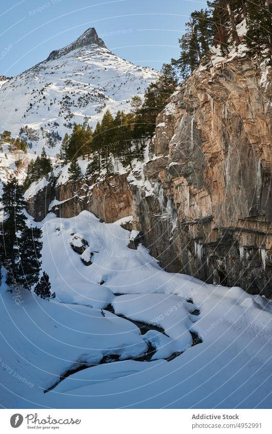 Frozen river in snowy rocky mountains in highland brook frozen winter cold nature formation flow stream scenery season rough ice freeze creek environment