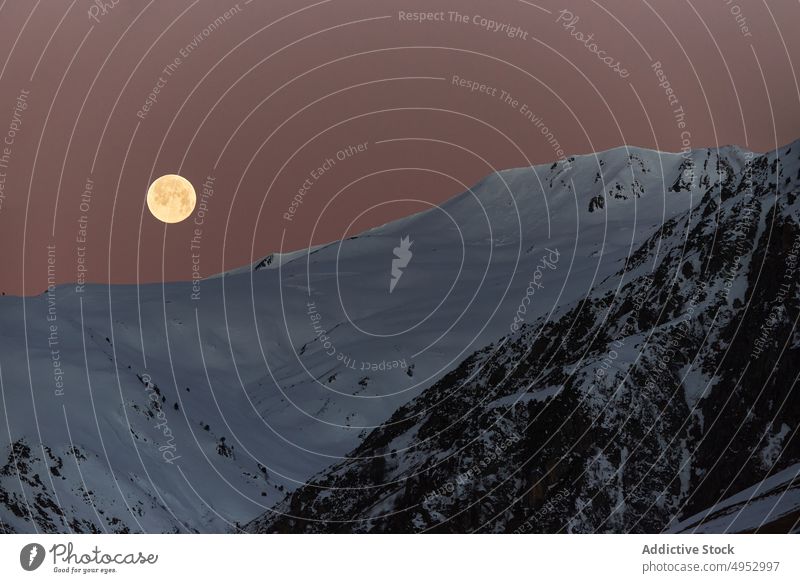 Moon over snowy mountains at night moon landscape range winter scenery wildlife nature frost ridge cold peak frozen full glow slope summit rock geology