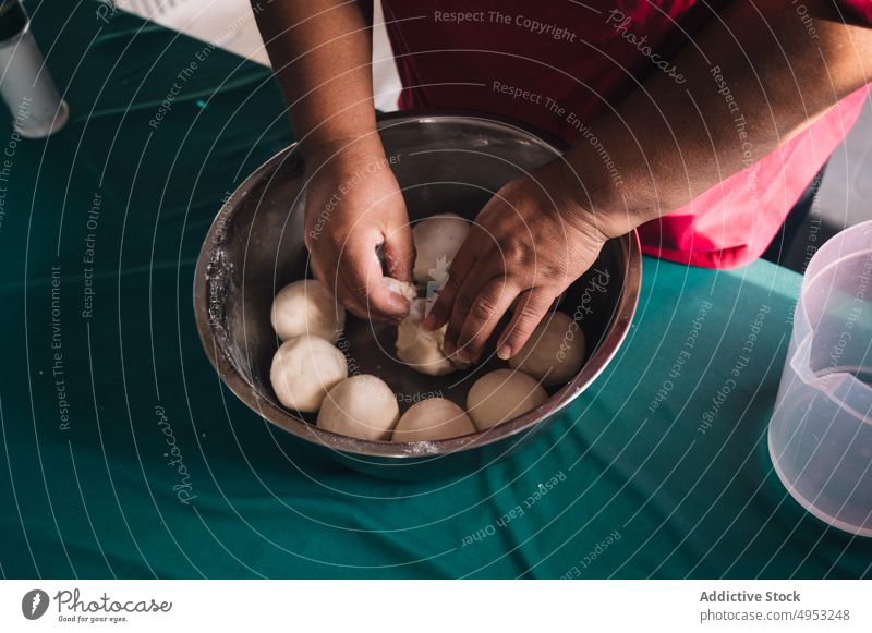 Crop ethnic woman preparing dough at home prepare culinary recipe raw product natural kitchen organic bowl homemade process tablecloth jug plump plus size cook