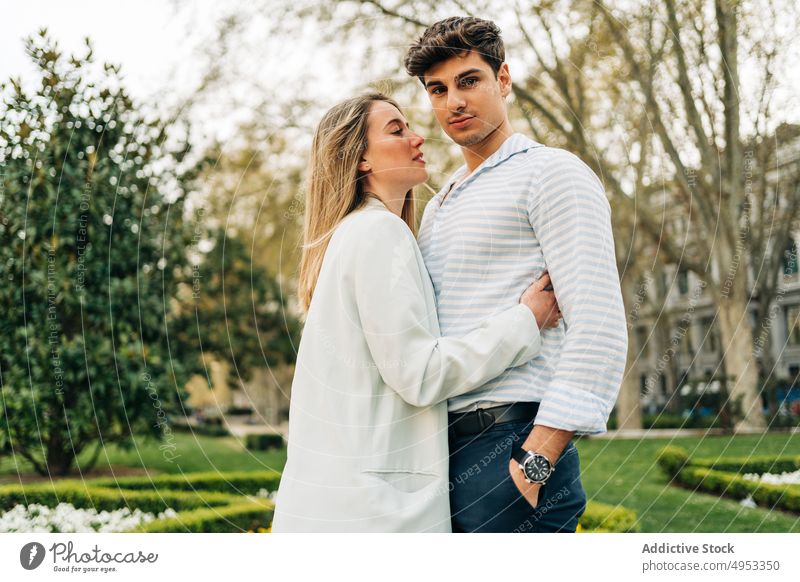 Stylish couple embracing in park in city hug embrace love garden tender relationship romantic cuddle together affection gentle bonding in love date amorous