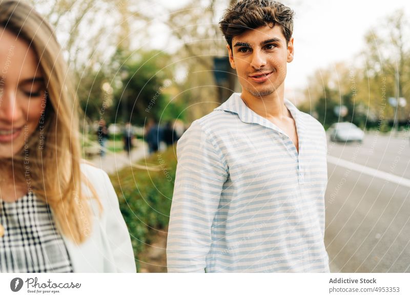 Cheerful couple crossing road in city holding hands walk stroll love together relationship street urban style trendy content smile happy girlfriend boyfriend