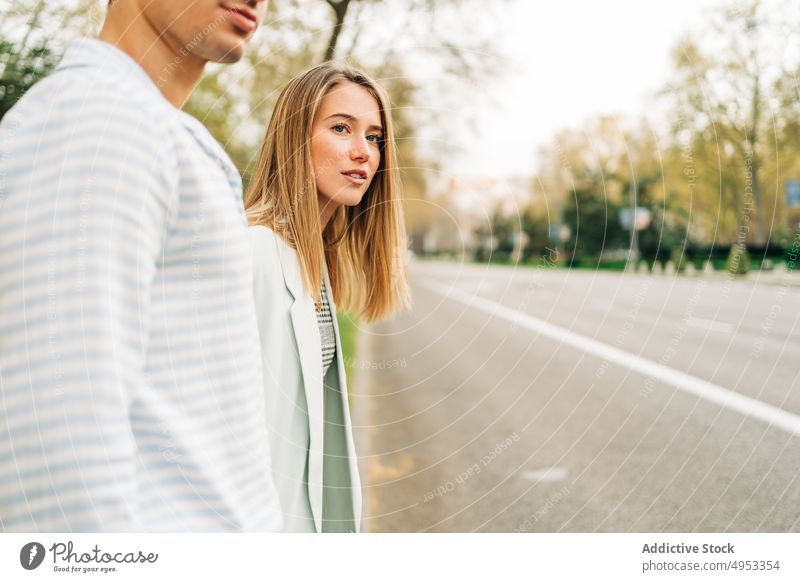 Happy couple crossing road in city holding hands walk stroll love together relationship street urban style trendy content smile happy girlfriend boyfriend