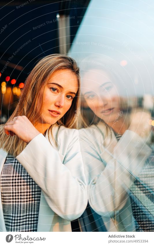 Dreamy woman standing in rooftop restaurant in evening dreamy cafe sunlight enjoy thoughtful female chill style relax glass window elegant sunset calm