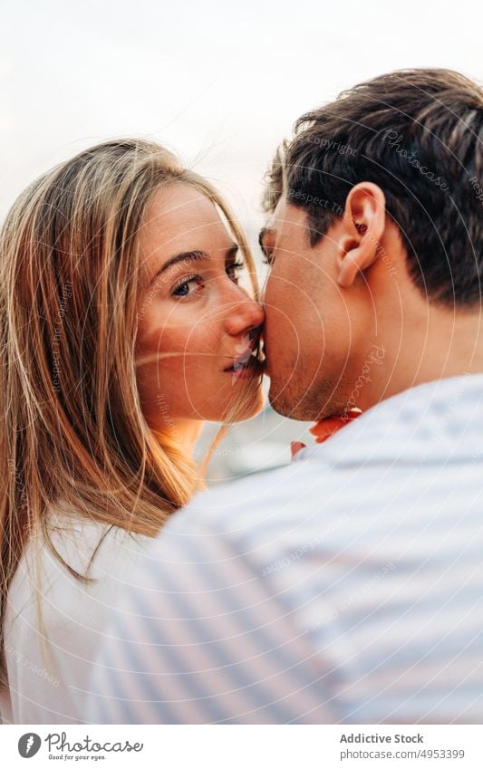 Loving couple kissing in rooftop cafe date romantic evening restaurant tender love serene hug embrace together relationship affection bonding romance tranquil