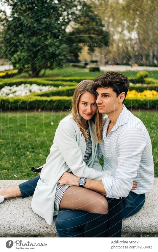 Stylish couple embracing in park in city hug embrace love garden tender relationship romantic cuddle together affection gentle bonding sit in love date amorous