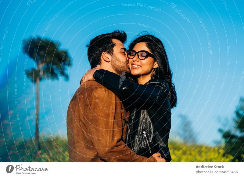 Ethnic couple spending time in countryside field relationship love spend time weekend soulmate nature blue sky romantic enjoy eyeglasses accessory summer meadow