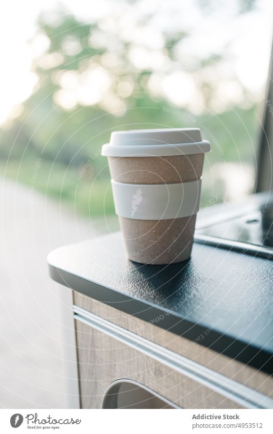 Cup of coffee placed on table in van cup takeaway paper cup drink camper beverage fresh style hot energy nature parked brew caffeine aroma natural mug to go