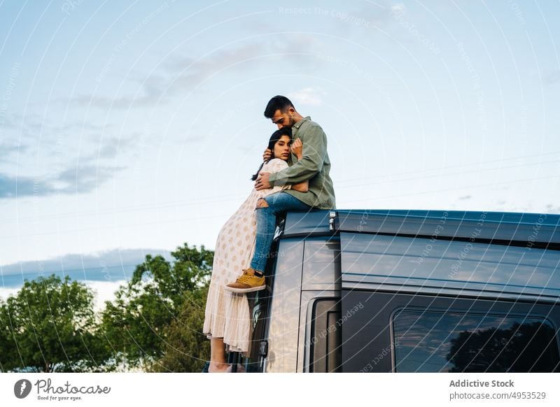 Romantic couple enjoying camping together in nature travel camper van embrace romantic love summer car sunset evening relationship countryside young support hug