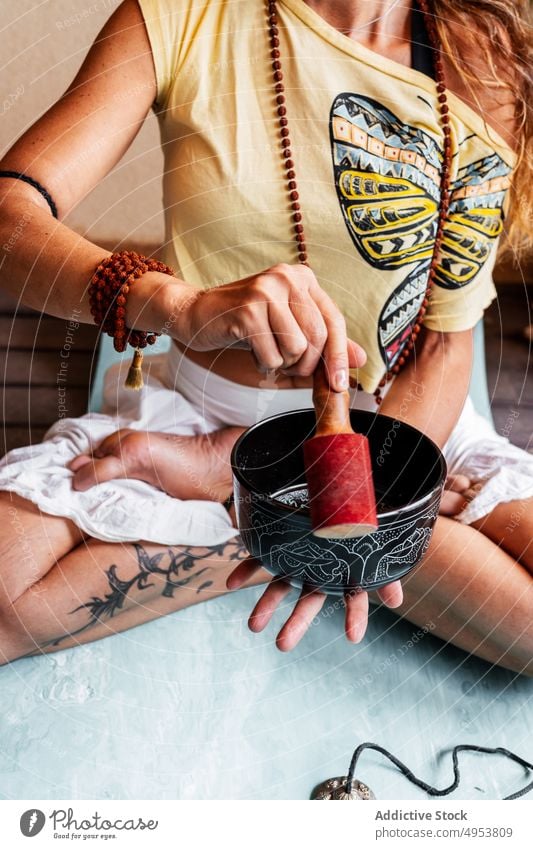 Yogi woman with Tibetan singing bowl tibetan meditate yoga harmony vibration zen spirit balance sound buddhism lotus pose female relax tranquil wellness