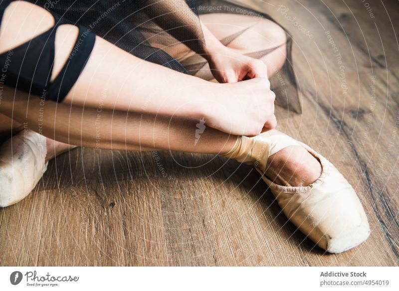 Crop ballerina tying pointe shoes pointes hands wearing person dancer elegance ballet performer sensuality posing artist ribbon putting on contemporary style