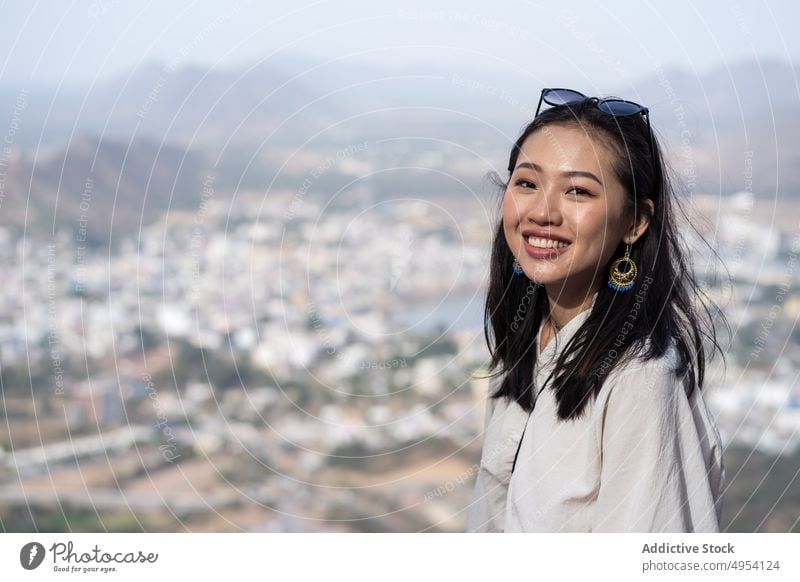 Cheerful Asian tourist against old city woman town smile visit ethnic happy pushkar india rajasthan female ancient cheerful aged holiday asian vacation