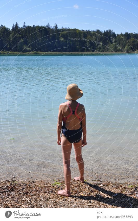 enjoying the summer | sporty senior woman in swimsuit stands on the lakeshore and enjoys the beautiful view. Human being Woman Senior citizen Adults Pensioner