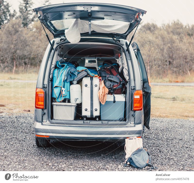 Traveling van filled with suitcase, bag and road trip stuff ready to start the route traveling across iceland. Sleeping outdoors, camping and exploring concepts. Copy space Image.