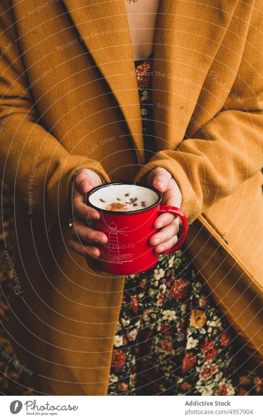 Woman with enamel cup of tasty beverage in garden woman mug drink warm picnic hand refreshment coffee coat food latte female healthy edible breakfast nutrient